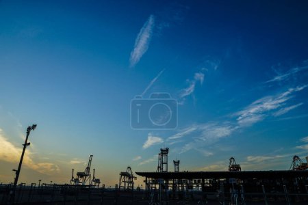 Photo for "Sunset view with crane group of Yokohama port" - Royalty Free Image