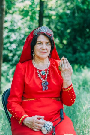 Photo for "the senior priestess with a butterfly on her fingers prepared for the rite of sacrifice. mystical pagan rite. pagans today." - Royalty Free Image