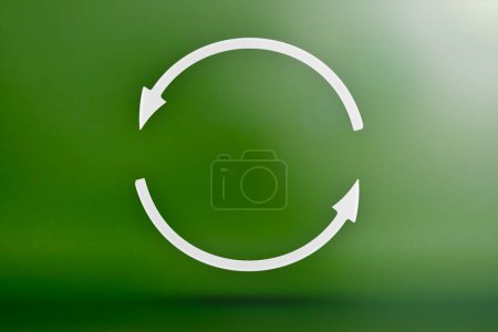 Photo for "Ecology, recycling symbol, white arrows form a circle. 3D image on a green background. Green products, green renewable energy, graph pointing up and down" - Royalty Free Image