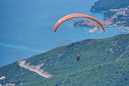Photo for "Two person fly on paragliding against city of Budva" - Royalty Free Image