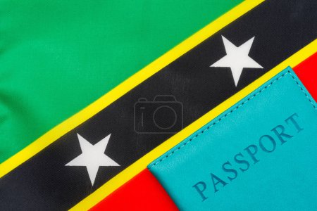 Photo for A passport stands against the flag of Saint Kitts and Nevis." - Royalty Free Image