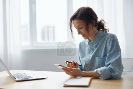 Photo for Smiling cheerful enjoyed good day lovely adorable curly lady chatting with friends online love using phone sitting at home office. Breakup for Social Media. Distant communication concept - Royalty Free Image