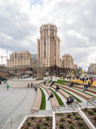 Photo for "MOSCOW, RUSSIA - May 01, 2022. Local people and tourists walk on square near Paveletsky railway. Modern urban architecture." - Royalty Free Image