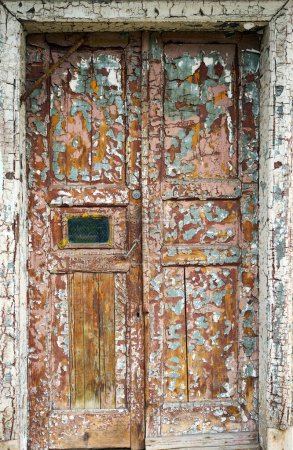 Photo for "old cracked brown door on the front of the house" - Royalty Free Image