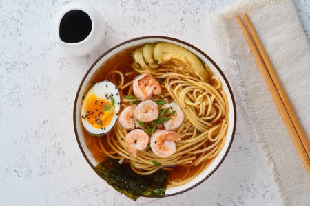 Photo for "Asian soup with noodles, ramen with shrimps, miso paste, soy sauce. White stone table" - Royalty Free Image