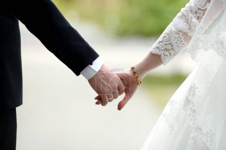 Photo for "Closeup view of married couple holding hands" - Royalty Free Image
