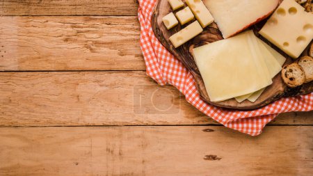 Photo for Different types cheeses wooden coaster with table cloth bench - Royalty Free Image