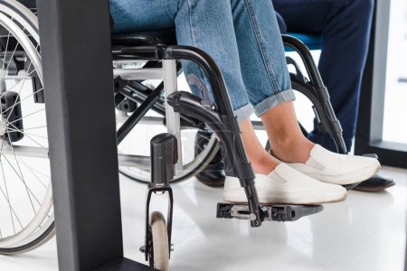 Photo for Disabled woman s feet wheel chair white floor - Royalty Free Image