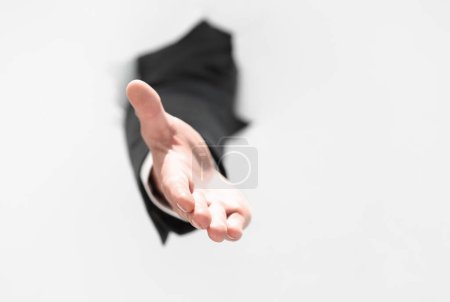 Photo for Men holding out his hand for a handshake - Royalty Free Image