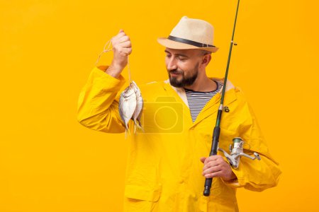 Photo for Front view proud fisherman holding catch fishing rod - Royalty Free Image