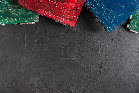 Photo for Elevated view of colorful computer circuit boards black backdrop - Royalty Free Image