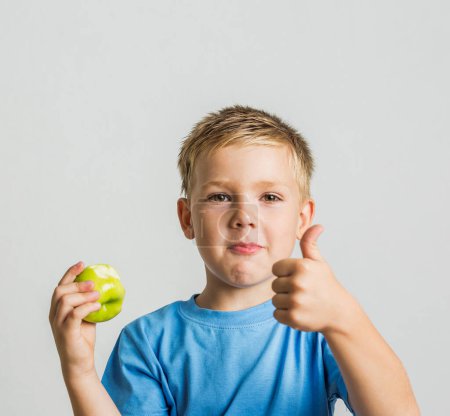 Photo for Front young boy with green apple - Royalty Free Image