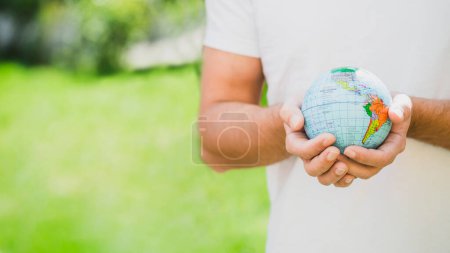 Photo for Mid section man holding globe hand - Royalty Free Image