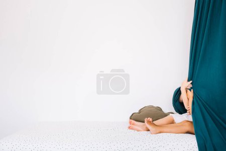 Photo for Girls hiding under curtains - Royalty Free Image