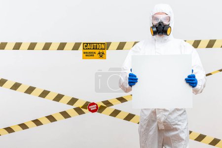 Photo for "man hazmat suit with blank sign" - Royalty Free Image