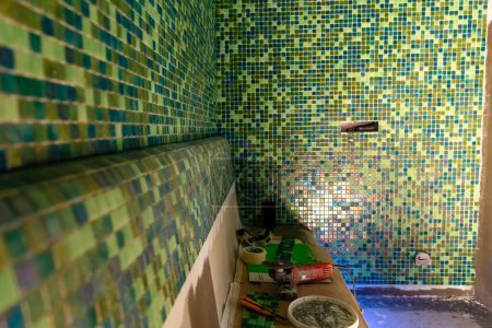 Photo for "Installation of mosaic tiles, modern green mosaic" - Royalty Free Image