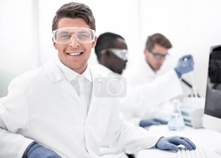 Photo for Modern scientist sitting in front of a computer monitor - Royalty Free Image