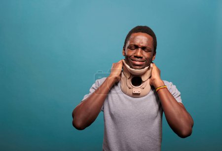 Foto de "Emotional guy wearing cervical collar to cure physical injury" - Imagen libre de derechos