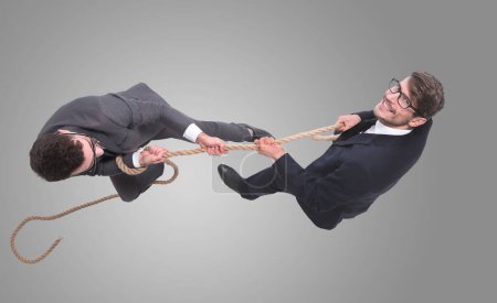 Photo for Two businessmen pulling a long rope. - Royalty Free Image