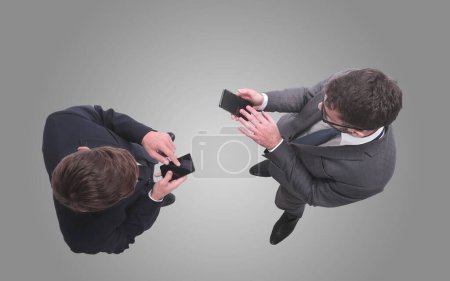 Foto de Dos hombres de negocios usando sus teléfonos inteligentes - Imagen libre de derechos
