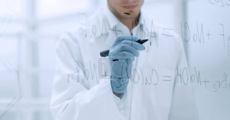 Photo for "scientist making notes on the glass Board at the time of the experiment" - Royalty Free Image