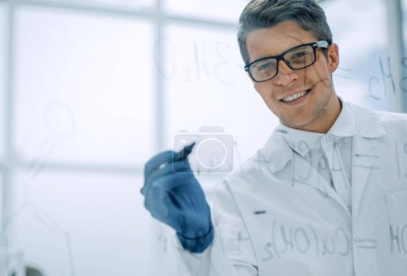 Photo for "successful scientist writes a formula on a glass Board" - Royalty Free Image