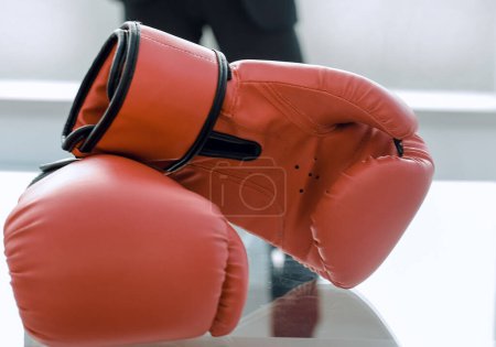 Photo for "Boxing gloves on the businessman's desktop" - Royalty Free Image