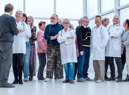 Photo for "Group Of Mature People And Doctors Indoors Full Length" - Royalty Free Image