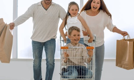 Photo for Happy family with cart and kids - Royalty Free Image