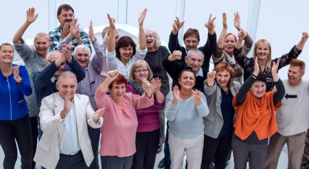 Photo for Group of mature friends raised their hands up and celebrate - Royalty Free Image