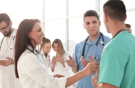 Photo for Diverse medical professionals standing in the hospital lobby. - Royalty Free Image