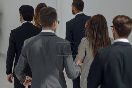 Photo for Business team walks through the office hall - Royalty Free Image