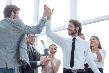 Photo for Corporate group of employees congratulating each other on the victory - Royalty Free Image