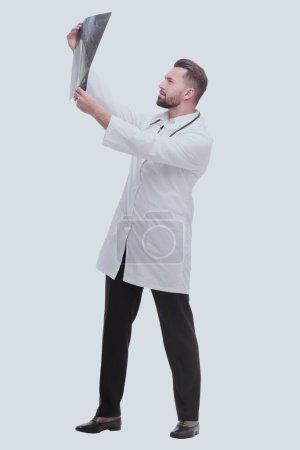 Photo for "in full growth. medical doctor looking closely at the x-ray" - Royalty Free Image