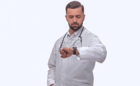 Photo for "in full growth. medical doctor looking at his wrist watch" - Royalty Free Image