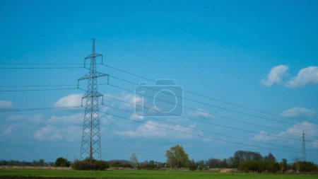 Photo for Power line pole, electrical Pylon, blue sky, clouds - Royalty Free Image