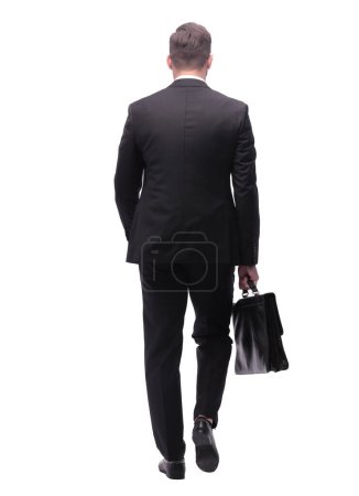 Foto de "Vista trasera. hombre de negocios con maletín de cuero dando un paso adelante" - Imagen libre de derechos