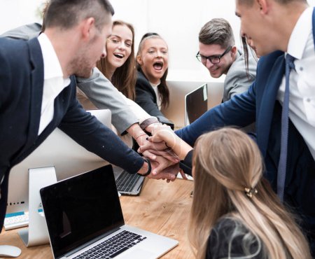 Photo for "business team is joining their palms on the desktop" - Royalty Free Image
