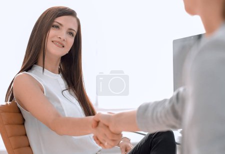 Photo for Two business women shake hands in the workplace - Royalty Free Image