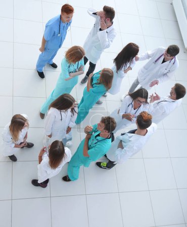 Photo for Male doctor standing in front of her colleagues, top view - Royalty Free Image