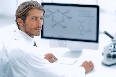 Photo for "Portrait of a male scientist with a monitor looking at the camer" - Royalty Free Image