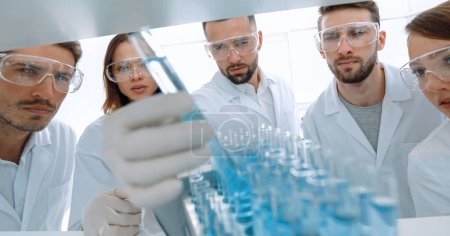 Photo for Background image is a group of microbiologists studying the liquid - Royalty Free Image