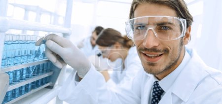 Photo for Close-up of a happy male scientist wearing safety glasses - Royalty Free Image