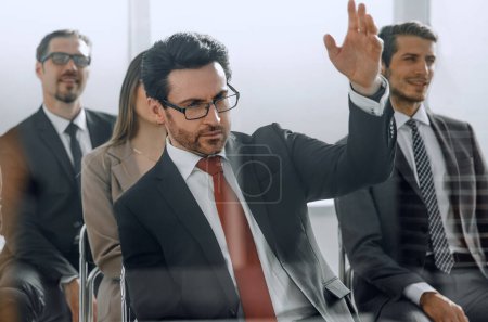 Photo for Handsome businessman raising his hand to ask question - Royalty Free Image
