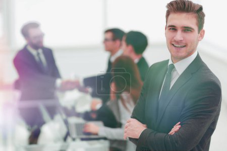 Photo for "young businessman on blurred office background" - Royalty Free Image