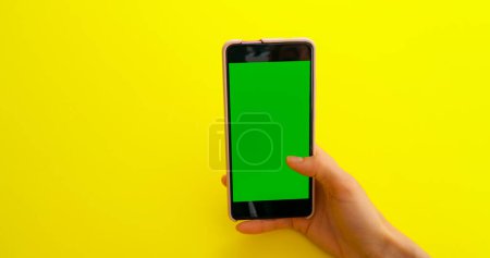 Photo for "Scrolling Gesture on Smartphone with Green Screen" - Royalty Free Image