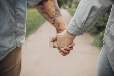 Photo for "the lovers walk holding hands. Large hands" - Royalty Free Image