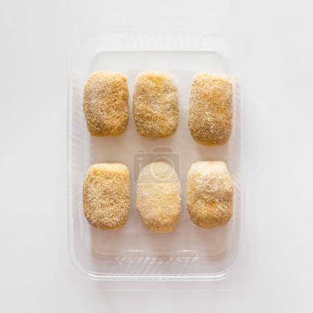 Photo for "Homemade frozen croquettes in transparent tray. Mediterranean and spanish cuisine. Preserved food for sale." - Royalty Free Image