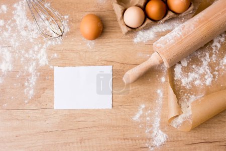 Photo for "rolling pin with eggs rack paper flour" - Royalty Free Image