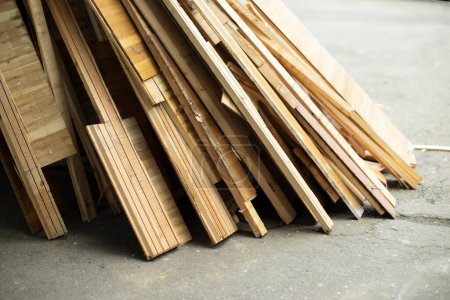Photo for "Broken parquet. Waste after repair. Boards from floor. Construction debris on street." - Royalty Free Image